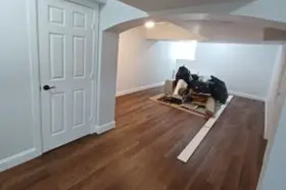 Full basement renovation with new flooring installation and finished walls by DLS Construction LLC